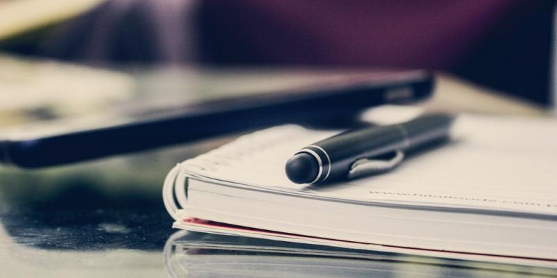 Photo of a notebook and pen.